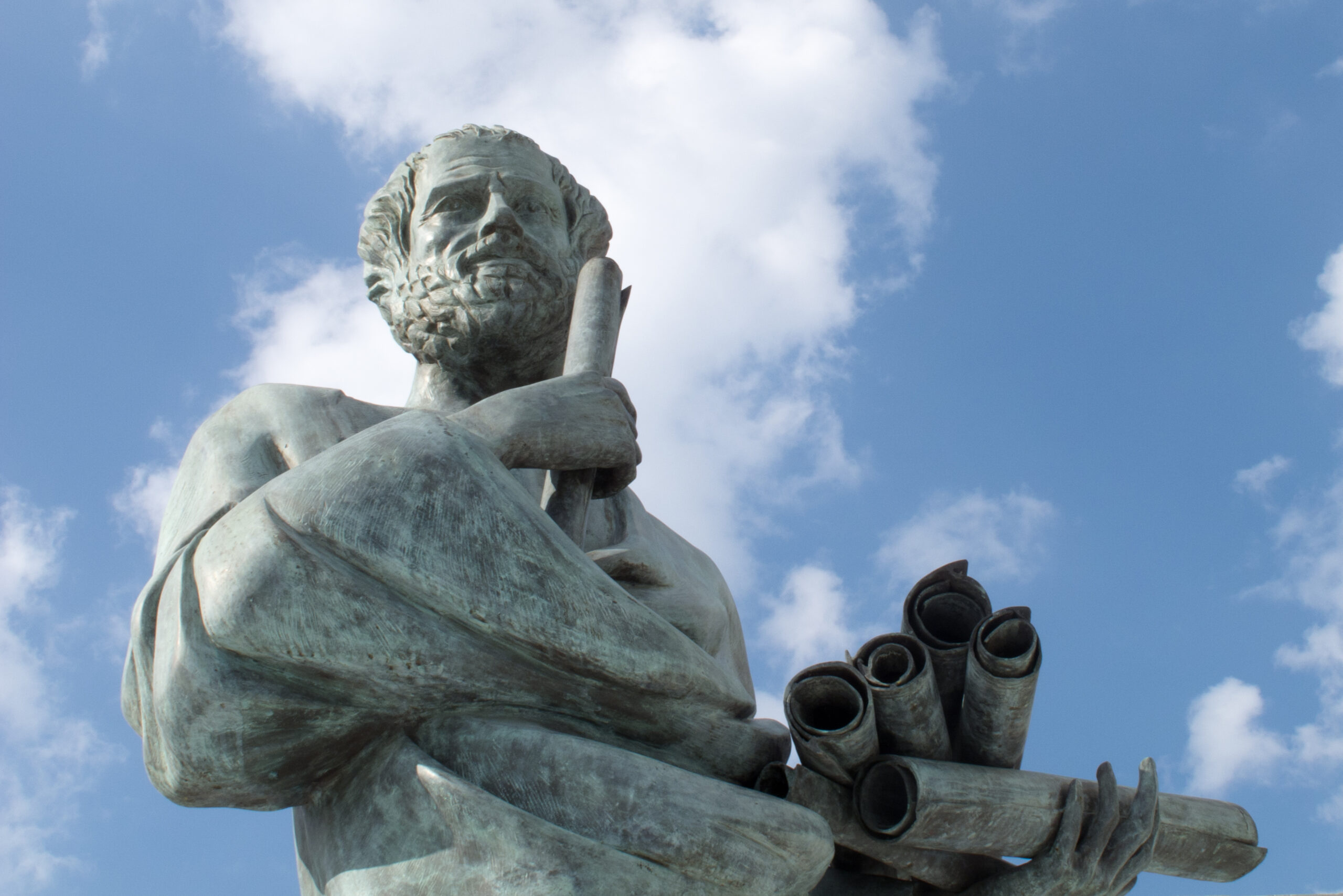 Classical marble statue holding scrolls