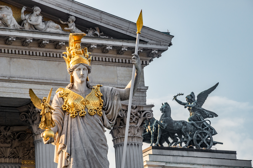 Statue of Athena with a gilded spear before a classical facade